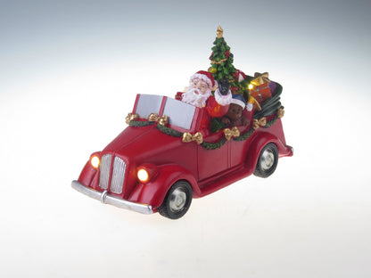 Kerstman in auto met draaiende boom